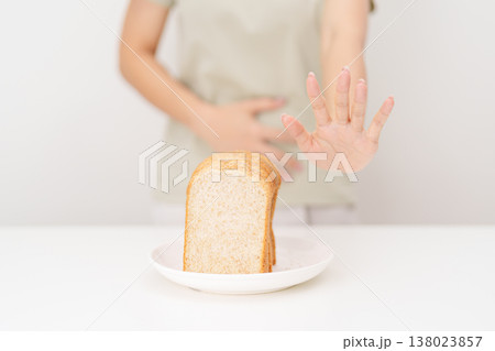 Gluten intolerance, Gluten free and celiac disease or Wheat allergy. woman with wheat bread and having abdominal pain after eat gluten. stomach ache, Nausea, Bloating, Gas, Diarrhea and Skin rash Gluten intolerance, Gluten free and celiac disease or Wheat allergy. woman with wheat bread and having abdominal pain after eat gluten. stomach ache, Nausea, Bloating, Gas, Diarrhea and Skin rash 138023857