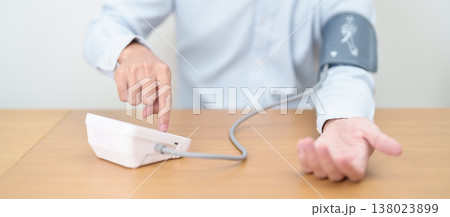 Man checking Blood pressure by Blood pressure monitor with Cuff. Systolic, SYS, Diastolic, DIA, Pulse, Hypertension, Hypotension, Heart rate, Cardiovascular Disease and May World hypertension day Man checking Blood pressure by Blood pressure monitor with Cuff. Systolic, SYS, Diastolic, DIA, Pulse, Hypertension, Hypotension, Heart rate, Cardiovascular Disease and May World hypertension day 138023899