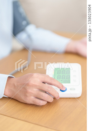 Man checking Blood pressure by Blood pressure monitor with Cuff. Systolic, SYS, Diastolic, DIA, Pulse, Hypertension, Hypotension, Heart rate, Cardiovascular Disease and May World hypertension day 138023904