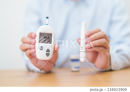 Hand checking Diabetes or Blood glucose self testing by digital blood glucose meter with lancet pen. high blood sugar level, World Diabetes Day, Glycemia, Hypoglycemia, Hyperglycemia and insulin Hand checking Diabetes or Blood glucose self testing by digital blood glucose meter with lancet pen. high blood sugar level, World Diabetes Day, Glycemia, Hypoglycemia, Hyperglycemia and insulin 138023909