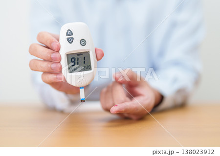 Hand checking Diabetes or Blood glucose self testing by digital blood glucose meter with lancet pen. high blood sugar level, World Diabetes Day, Glycemia, Hypoglycemia, Hyperglycemia and insulin Hand checking Diabetes or Blood glucose self testing by digital blood glucose meter with lancet pen. high blood sugar level, World Diabetes Day, Glycemia, Hypoglycemia, Hyperglycemia and insulin 138023912