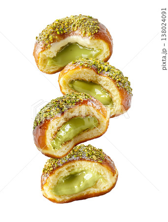 Multiple pistachio glazed donuts with crushed nuts isolated on a white background, concept of sweet bakery treats 138024091