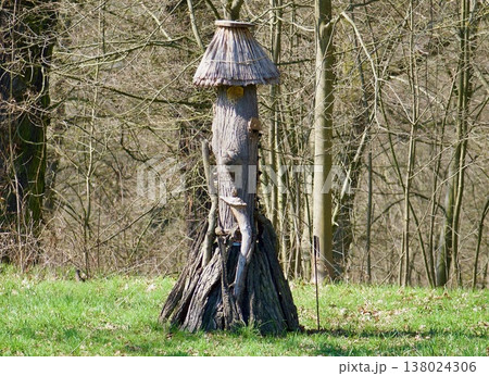 Handmade Wooden Insect Hotel with Thatched Roof in a Spring Garden. 138024306