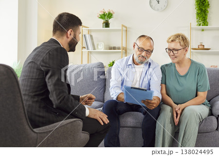 Mature couple meeting a professional agent for home consultation and agreement 138024495