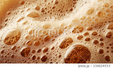 Foamy beer beverage bubbles in macro style on warm glowing background, representing freshness and effervescence 138024553