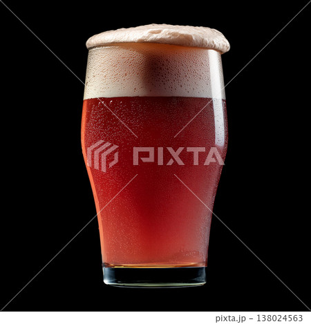 Foamy red ale beer in a tall glass with creamy foam head, isolated on black background, concept of refreshment and taste 138024563