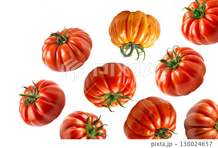 Multiple ripe heirloom tomatoes with ridged textures scattered and on a white background, natural food and healthy eating concept Multiple ripe heirloom tomatoes with ridged textures scattered and on a white background, natural food and healthy eating concept 138024657