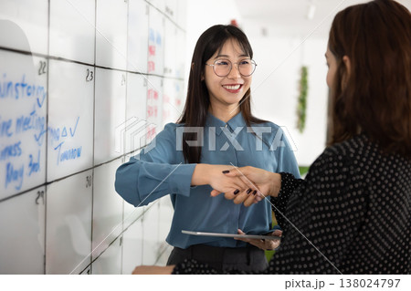 Happy Asian business leader woman shaking hands with partner 138024797
