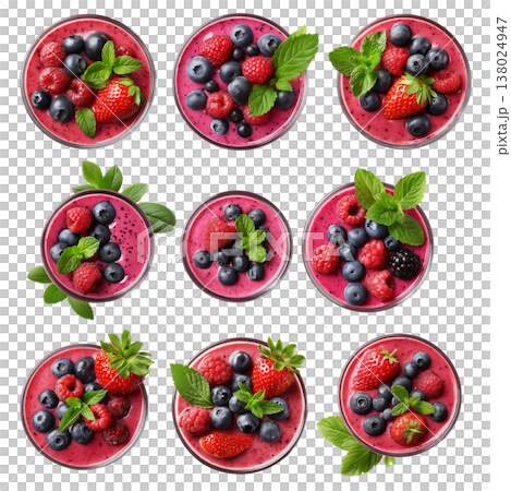Glass bowl filled with mixed berry smoothie topped with blueberries, raspberries, strawberry, and mint leaves on white 138024947