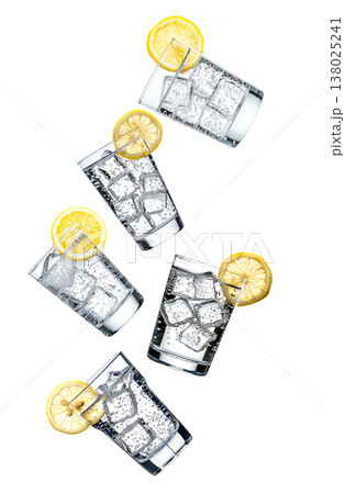 Multiple glasses of sparkling mineral water with lemon slices isolated on white background, expressing freshness Multiple glasses of sparkling mineral water with lemon slices isolated on white background, expressing freshness 138025241