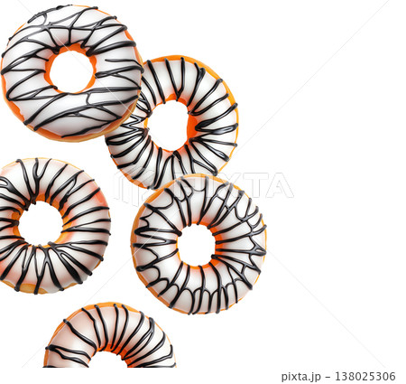 Multiple round glazed donuts with white icing and chocolate drizzle isolated on white background, concept of sweet dessert concept 138025306