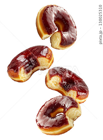 Multiple bitten jelly donuts with glossy glaze isolated on white background. Concept of sweet craving or tasty dessert temptation 138025310