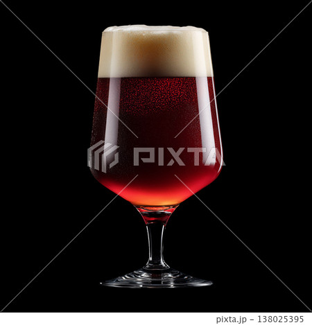 Foamy red ale beer in a tall tulip glass with creamy foam head, isolated on black background, concept of refreshment and taste 138025395