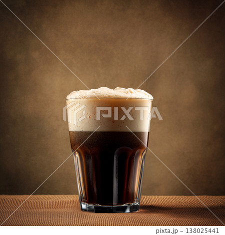 Glass of dark stout beer with foam on brown wooden table and solid backdrop, concept of refreshment and taste feel Glass of dark stout beer with foam on brown wooden table and solid backdrop, concept of refreshment and taste feel 138025441