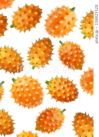 Multiple horned orange kiwano fruits with green tips isolated on white background, concept of exotic fruit freshness 138025528