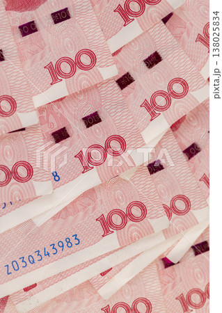 red Chinese money in denominations of one hundred yuan, heap of paper Chinese banknotes in denominations of 100 yuan 138025834