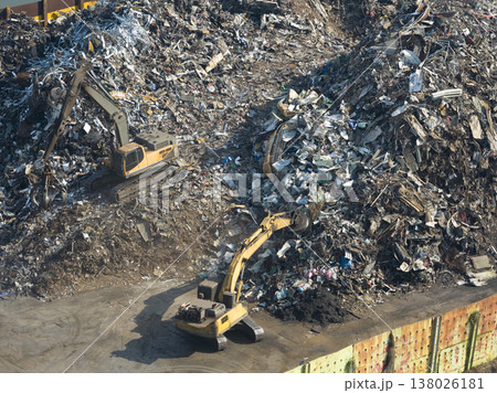 Aerial view of bustling recycling plant shows waste being sorted with automated machinery and heavy equipment 138026181