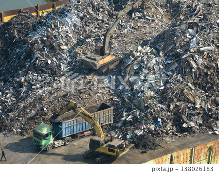 Aerial view of bustling recycling plant shows waste being sorted with automated machinery and heavy equipment Aerial view of bustling recycling plant shows waste being sorted with automated machinery and heavy equipment 138026183