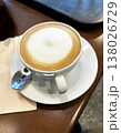a coffee latte on brown table 138026729