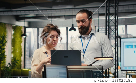 Team of staff members work with high tech and performance metrics, aligning business vision and organizational goals to drive success within a multinational company environment. 138027186