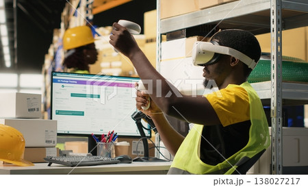 Black staff uses VR glasses for 3D simulation powered by artificial intelligence, supporting order fulfillment and inventory control. Person monitoring parcel tracking for shipment. Camera B. 138027217