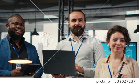Portrait of diverse business associates analyzing data insights meeting in office, consulting the analysis forecast before developing a new strategy for the enterprise activity. Camera B. 138027237