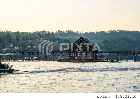 Wooden pavilion and Mon Bridge at sunset in Kanchanaburi 138028310