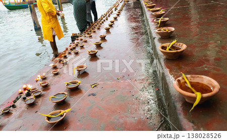 Oil Lamps (Diyas) Lined Along River Ghat During Ritual in Mathura 138028526