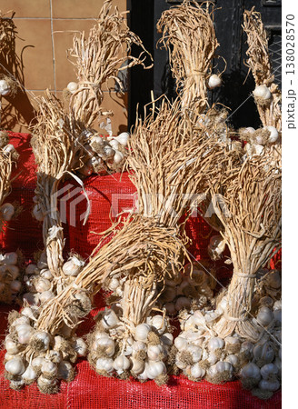 Large, intertwined bunches of dried garlic 138028570