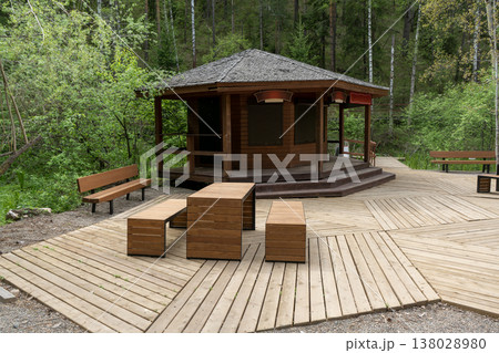 Serene Wooden Gazebo and Benches on Decked Boardwalk in Forest Park Picnic Area Serene Wooden Gazebo and Benches on Decked Boardwalk in Forest Park Picnic Area 138028980