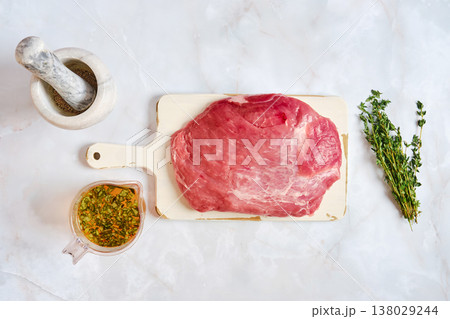 Preparation of pork shoulder for cooking with fresh herbs and seasoning mix Preparation of pork shoulder for cooking with fresh herbs and seasoning mix 138029244