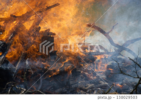 Wildfire Flames Consuming Dry Wood And Branches With Thick Smoke And Glowing Embers 138029503