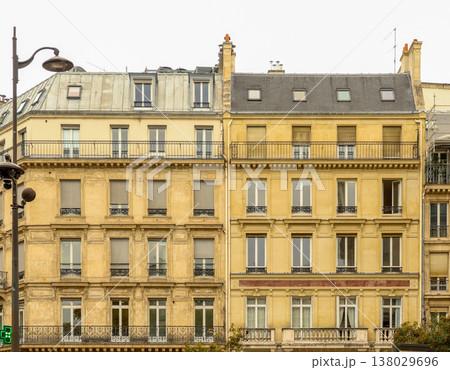 Haussmann style apartment buildings in Paris with classic architecture, windows, balconies, and dormer roofs 138029696