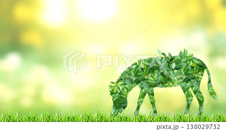 Zebra silhouette made of green leaves on sunny background. Ecology, global ecological resource, go green concept. Environmental conservation, wildlife protection, Eco-friendly, Green Energy 138029732