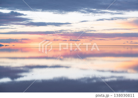 Serene sunset sky reflection over vast salt flat in Uyuni Bolivia 138030811