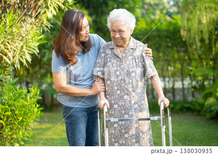 Asian elderly woman disability patient walk with walker in park. 138030935