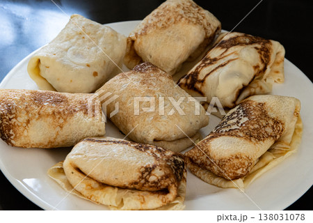 Plate of homemade stuffed pancakes served with filling. Traditional dish suitable for breakfast or dessert. Plate of homemade stuffed pancakes served with filling. Traditional dish suitable for breakfast or dessert. 138031078