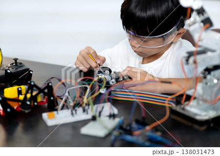 Asian boy is paying attention and adding and improving Asian boy is paying attention and adding and improving 138031473