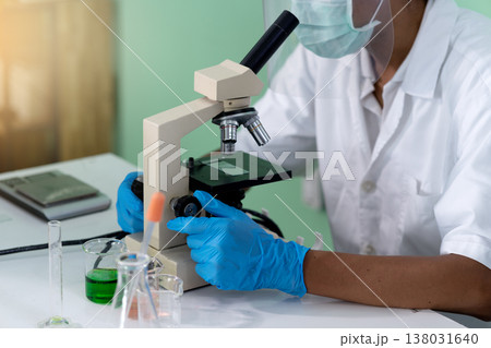 Scientist analyzing matter or germ using microscope Scientist analyzing matter or germ using microscope 138031640