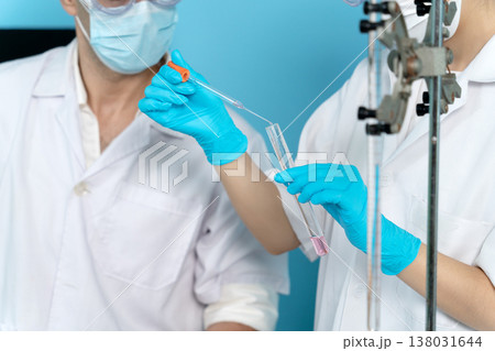 The lab team is looking at the chemicals and the mixing The lab team is looking at the chemicals and the mixing 138031644