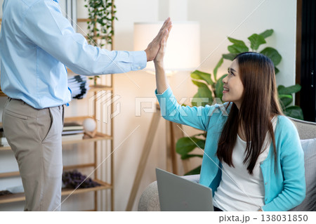 young asian woman sitting tapping hands with colleague or young asian woman sitting tapping hands with colleague or 138031850