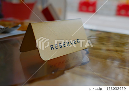 Reserved table tent card sign in restaurant closeup with blurred background in Hong Kong dining establishment 138032439