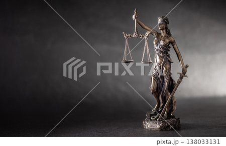 A bronze statue of Lady Justice on a dark, textured background with strong side lighting that highlights her details and symbolism. The composition, with free space on the left, is ideal for A bronze statue of Lady Justice on a dark, textured background with strong side lighting that highlights her details and symbolism. The composition, with free space on the left, is ideal for 138033131