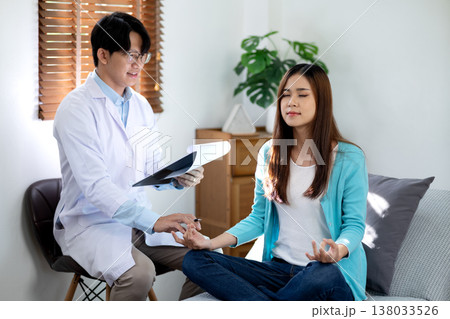 Asian psychiatrist is examining and consulting a young woman  patient 138033526