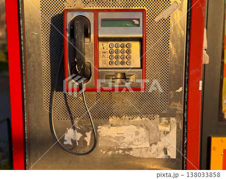 Vintage old public payphone with keypad and handset on metal wall. Retro communication technology, urban detail, nostalgic concept Vintage old public payphone with keypad and handset on metal wall. Retro communication technology, urban detail, nostalgic concept 138033858