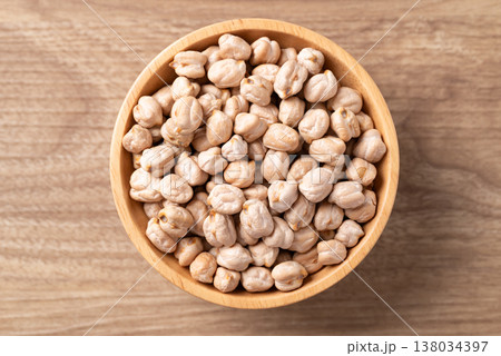 Organic raw chickpeas in a wooden bowl, healthy food ingredient, Table top view 138034397