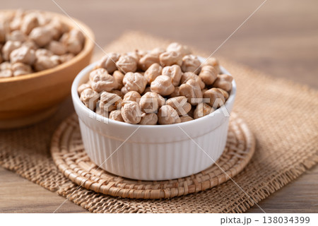 Organic raw chickpeas in a white bowl, healthy food ingredient Organic raw chickpeas in a white bowl, healthy food ingredient 138034399