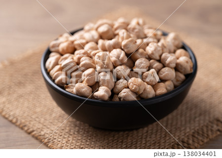 Organic raw chickpeas in a black bowl, healthy food ingredient 138034401
