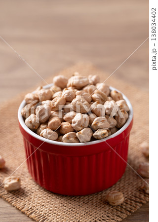 Organic raw chickpeas in a red bowl, healthy food ingredient 138034402