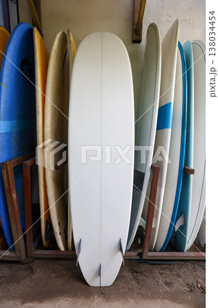 Surfboards in rack with white longboard in center Surfboards in rack with white longboard in center 138034454